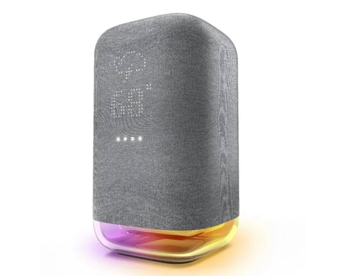 Gray fabric smart speaker with illuminated LED display on front and colorful light ring at base