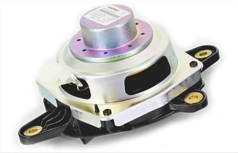 Automotive engine motor mount with white casing, purple top component, and black mounting brackets with brass fasteners