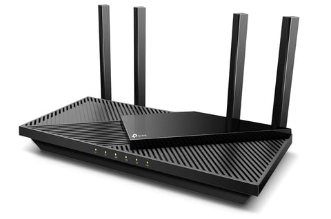 Black wireless Wi-Fi router with four external antennas and ribbed surface design