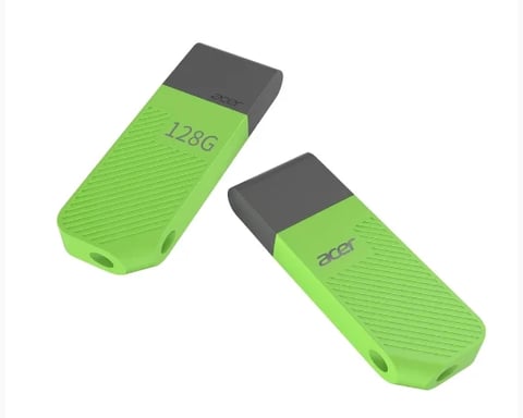 Two green USB flash drives with black caps and horizontal ribbed texture, one labeled 128G