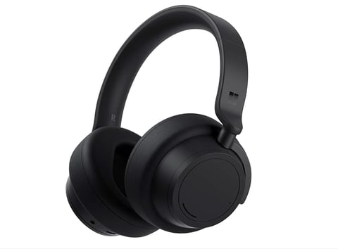 Black wireless over-ear headphones with padded ear cups and adjustable headband on white background