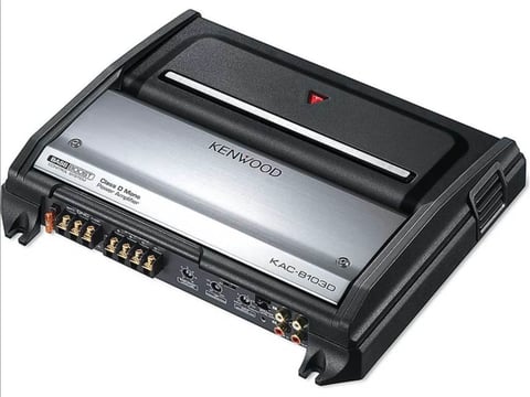 Kenwood KAC-9104D car amplifier with silver and black chassis, showing top view with connection terminals and control panel