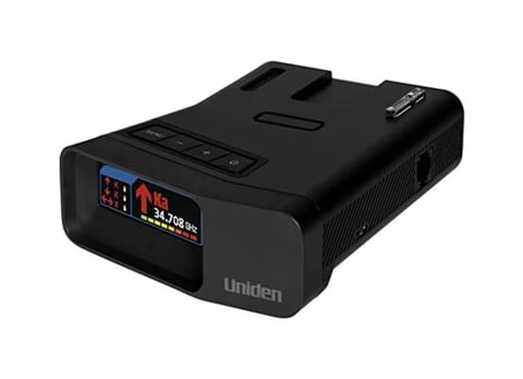 Black Uniden radar detector with digital display showing speed readings and red warning indicator