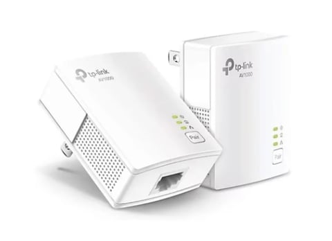 Two white TP-Link powerline network adapters with ethernet ports and LED indicators for home network extension