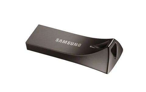 Samsung USB flash drive, metallic gray bar design with curved end, viewed from an angled perspective