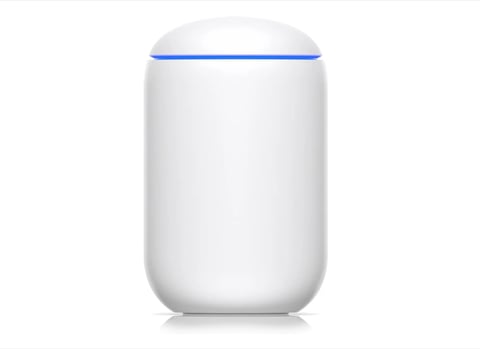 White cylindrical smart speaker device with blue ring light at the top