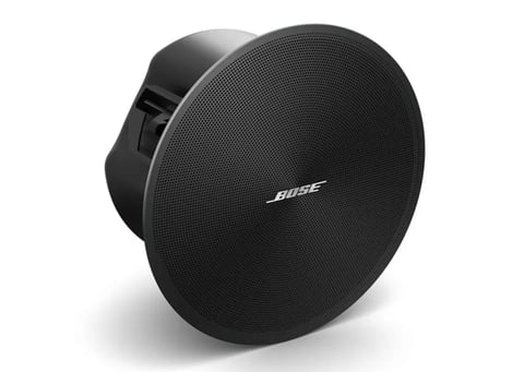 Black Bose ceiling speaker with round grille and mounting bracket visible from the side