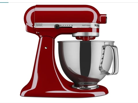 Red KitchenAid stand mixer with stainless steel bowl on white background