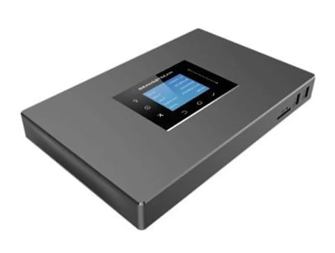 Gray mobile router with small touchscreen display mounted on top, showing network connectivity interface