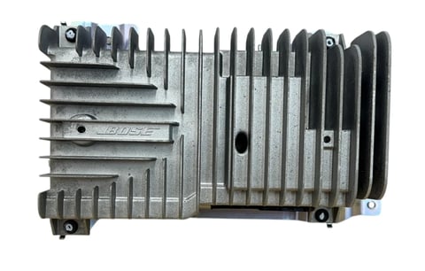Metallic automotive engine control module with ribbed cooling fins and mounting points